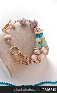 author gold  plated bracelete with pearls and gemstones. fashion and jewelry concept