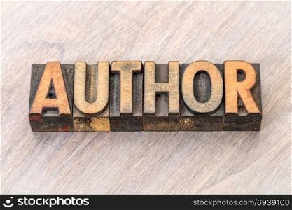 Author word in vintage letterpress wood type against grained wood