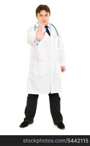 Authoritative medical doctor showing stop gesture isolated on white&#xA;