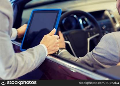 auto business, car sale, consumerism and people concept - close up of men with tablet pc computer in auto show or salon