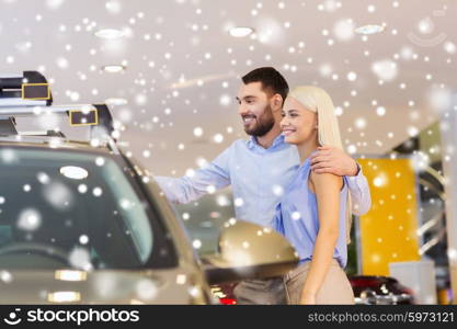 auto business, car sale, consumerism and people concept - happy couple buying car in auto show or salon over snow effect