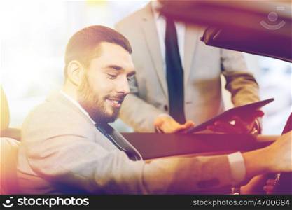 auto business, car sale, consumerism and people concept - happy man with car dealer in auto show or salon