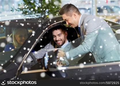 auto business, car sale, technology and people concept - happy couple with car dealer with tablet pc computer in auto show or salon over snow effect