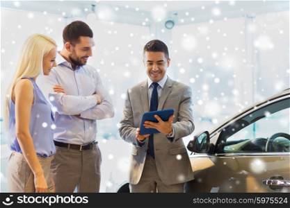 auto business, car sale, technology and people concept - happy couple with car dealer in auto show or salon over snow effect
