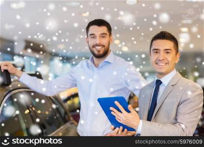 auto business, car sale, technology and people concept - happy man and car dealer with tablet pc computer in auto show or salon over snow effect