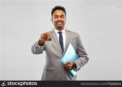 auto business, sale and people concept - happy indian man showing car key. happy indian man showing car key
