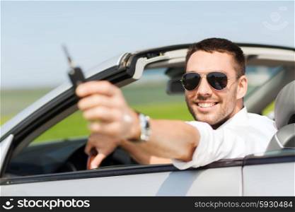 auto business, transport, leisure and people concept - happy man in cabriolet showing car key