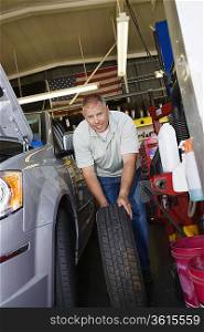 Auto Mechanic Changing a Tire