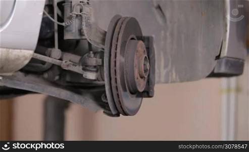 Auto Mechanic Check Repaired Car Wheel