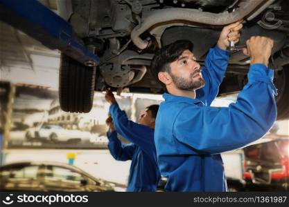Auto mechanic checking problem for the car engine at the garage,technician or engineer professional work for customer