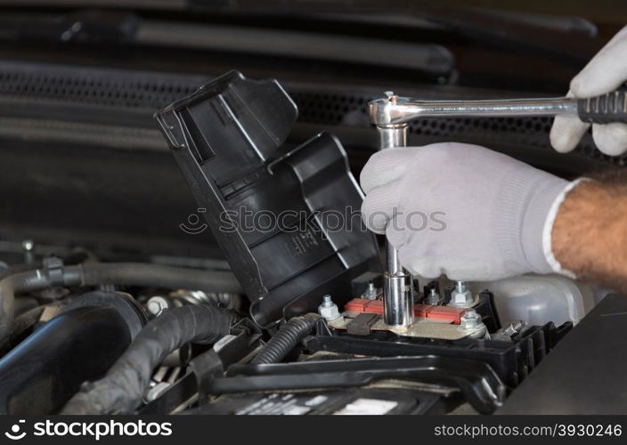 Auto Mechanic performing maintenance on the engine