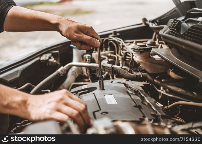 Auto mechanic working in garage Technician Hands of car mechanic working in auto repair Service and Maintenance car check.