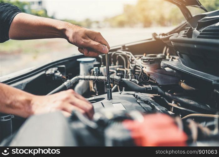 Auto mechanic working in garage Technician Hands of car mechanic working in auto repair Service and Maintenance car check.