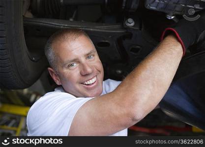 Auto Mechanic Working on Car