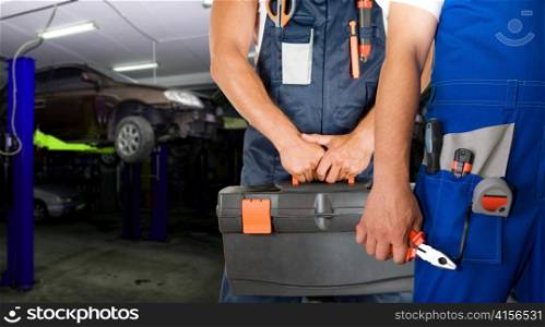Auto mechanics closeup standing in his workshop