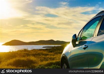 Auto parking on seashore in sunset time. Rear view mirror closed for safety at car park.. Car parking on seashore in sunset time