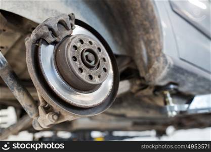 auto service and maintenance concept - car brake disc at repair station. car brake disc at repair station