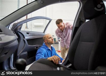 auto service, repair, maintenance and people concept - mechanic and man or owner at car shop