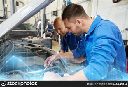 auto service, repair, maintenance and people concept - mechanic men with wrench repairing car at workshop. mechanic men with wrench repairing car at workshop