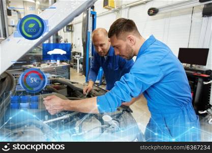 auto service, repair, maintenance and people concept - mechanic men with wrench repairing car at workshop. mechanic men with wrench repairing car at workshop