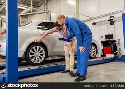 auto service, repair, maintenance and people concept - mechanic with clipboard and man or owner at car shop