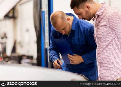 auto service, repair, maintenance and people concept - mechanic with clipboard and man or owner looking at broken car at shop