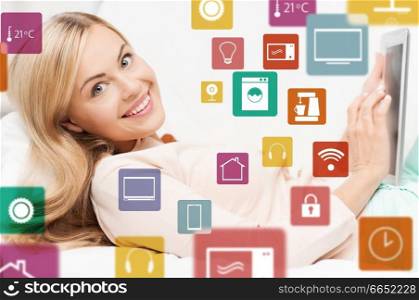 automation, internet of things and technology concept - woman with tablet computer and virtual projection of smart home icons. woman with tablet computer and smart home icons
