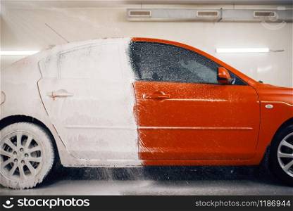 Automobile is half in foam, car wash service, nobody. Automobile on carwash station, car-wash business concept