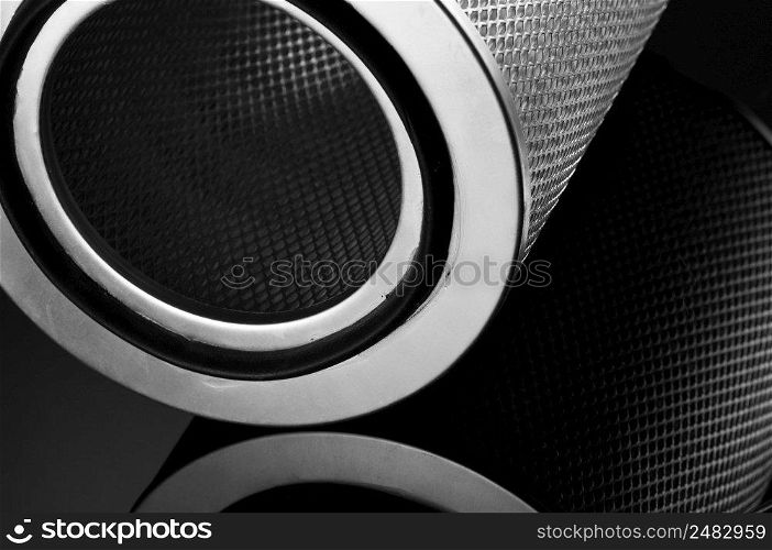 automotive filter cylindrical shape on a black background with reflection. automobile filter on a black background