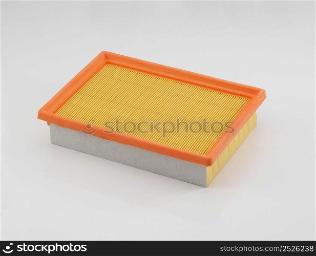 automotive filter square shape orange on a white background . automobile filter on a white background