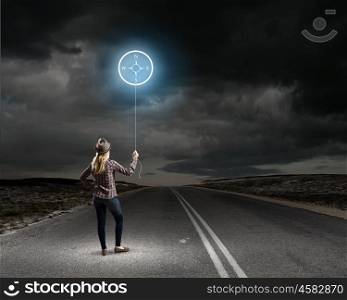 Autostop traveling. Rear view of woman in casual holding balloon in hand