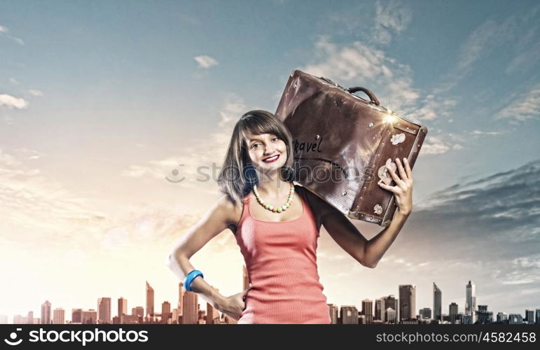 Autostop traveling. Young pretty woman tourist with suitcase walking on road