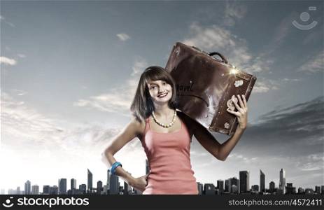 Autostop traveling. Young pretty woman tourist with suitcase with suitcase on shoulder
