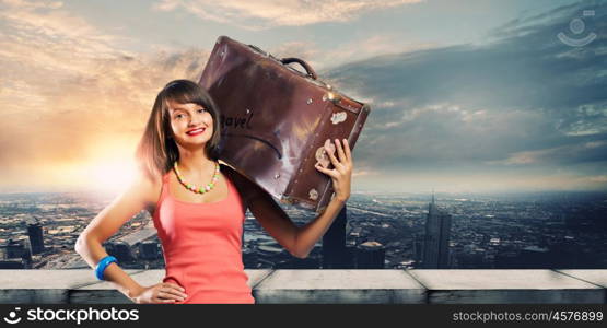 Autostop traveling. Young pretty woman tourist with suitcase with suitcase on shoulder