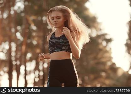 autumn adult girl running sport / beautiful active girl adult running and practicing outdoor sports in the autumn season