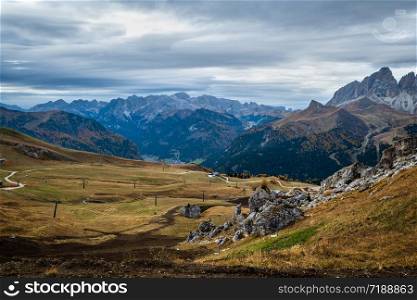 Autumn alpine Dolomites mountain scene near Pordoi Pass, Trentino, Italy. Picturesque traveling, seasonal, nature and countryside beauty concept scene.