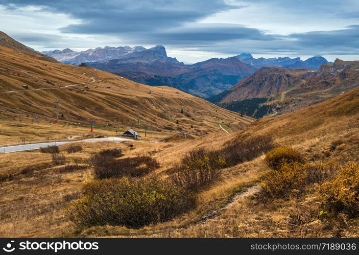 Autumn alpine Dolomites mountain scene near Pordoi Pass, Trentino, Italy. Picturesque traveling, seasonal, nature and countryside beauty concept scene.
