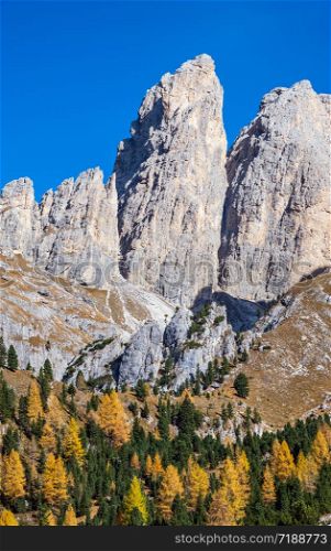 Autumn alpine Dolomites mountain scene, Sudtirol, Italy. Peaceful view near Gardena and Sella Pass. Picturesque traveling, seasonal, nature and countryside beauty concept scene.