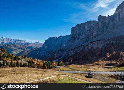 Autumn alpine Dolomites mountain scene, Sudtirol, Italy. Peaceful view near Gardena Pass. Picturesque traveling, seasonal, nature and countryside beauty concept scene.