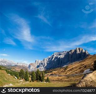 Autumn alpine Dolomites mountain scene, Sudtirol, Italy. Peaceful view near Sella Pass. Picturesque traveling, seasonal, nature and countryside beauty concept scene.