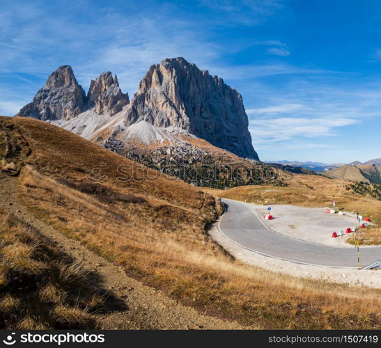 Autumn alpine Dolomites mountain scene, Sudtirol, Italy. Peaceful view near Sella Pass. Picturesque traveling, seasonal, nature and countryside beauty concept. People, cars and signs unrecognizable.
