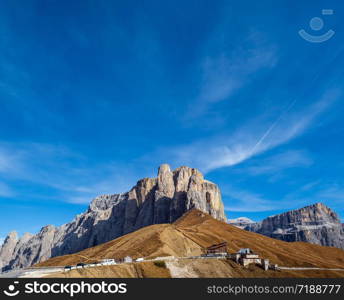 Autumn alpine Dolomites mountain scene, Sudtirol, Italy. Peaceful view near Sella Pass. Picturesque traveling, seasonal, nature and countryside beauty concept scene.