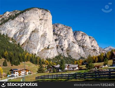 Autumn alpine Dolomites mountain scene, Sudtirol, Italy. Peaceful view near Wolkenstein in Groden, Selva di Val Gardena. Picturesque traveling, seasonal, nature and countryside beauty concept scene.