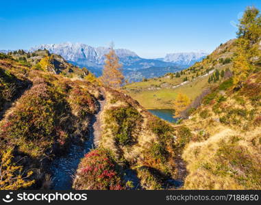 Autumn alpine Grosser Paarsee or Paarseen lake, Dorfgastein, Land Salzburg, Austria. Alps Hochkonig rocky mountain group view in far. Picturesque hiking, seasonal, and nature beauty concept scene.