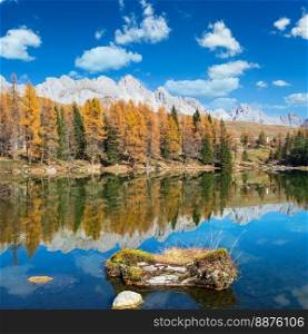 Autumn alpine mountain lake near San Pellegrino Pass, Trentino, Dolomites Alps, Italy. Picturesque traveling, seasonal and nature beauty concept scene.