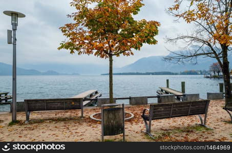 Autumn Alps mountain lake Mondsee misty view, Seepromenade Mondsee, Salzkammergut, Upper Austria.