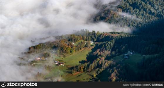 Autumn Alps mountain misty morning view from Jenner Viewing Platform, Schonau am Konigssee, Bavaria, Germany. Picturesque traveling, seasonal and nature beauty background scene.