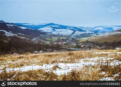 Autumn and winter are meeting on the fields. Pastoral landscape. Autumn and winter