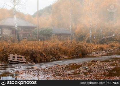 Autumn . Autumn at mountain village. Morning fog at river