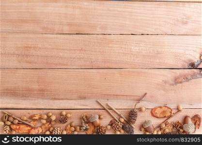 autumn background. cones,acorns and pieces of wood on a wooden background. the view from the top.